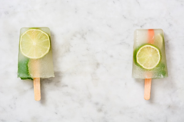 Paleta de fruta de limón sobre mármol blanco.