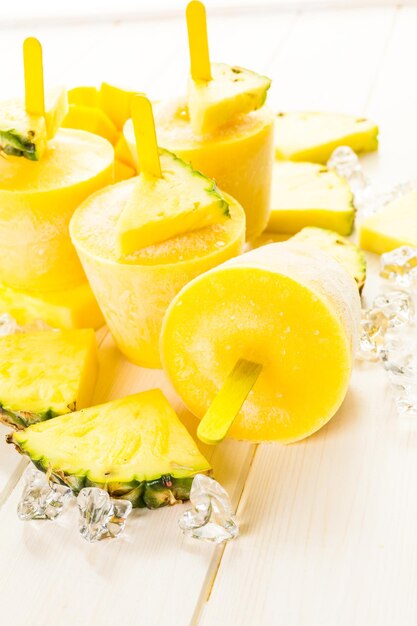 Paletas heladas caseras bajas en calorías elaboradas con mando, piña y leche de coco.