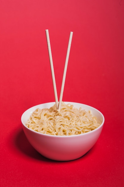 Foto palillos en un tazón con fideos