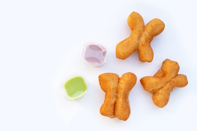 Foto palitos de massa frita ou pão chinês em fundo branco.