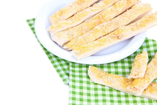 Palitos de pan sabroso en un plato aislado en blanco