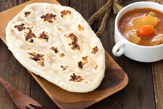 Pan indio de ajo naan en madera