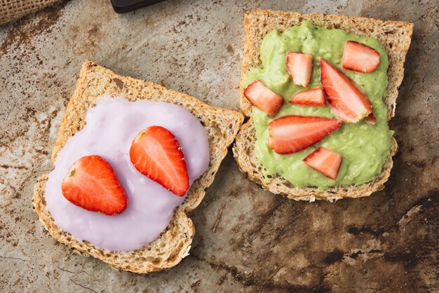 Pan integral de puré de aguacate y arándanos con fresa.