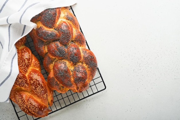 Pan jalá Composición de la ceremonia de kiddush sabático Pan de jalá trenzado casero recién horneado tradicional para Shabat y días festivos sobre fondo gris claro Shabat Shalom Vista superior Copiar espacio