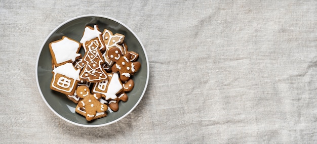 Pan de jengibre en un plato para Navidad sobre tela ligera arrugada