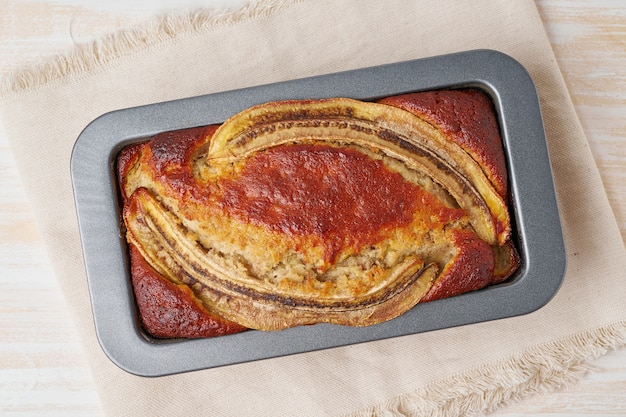 Pan de plátano en una sartén. Pastel con plátano, chocolate, nuez.