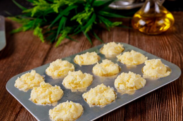 Pan de queso brasileño crudo en molde para hornear con aceite.