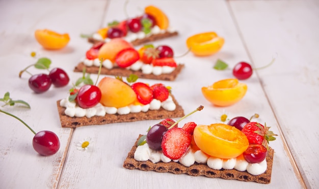 Pan con queso crema, frutas y frutos del bosque