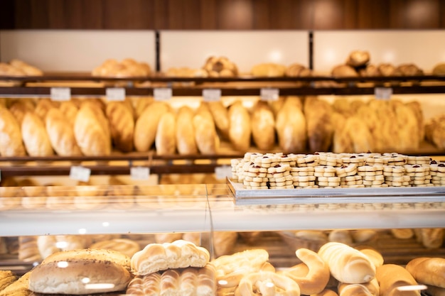 Panadería vista interior y estantes llenos de panecillos de pan recién horneados y galletas