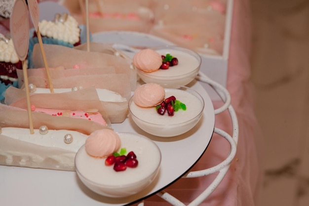 Panakota na mesa de casamento Bolo de casamento branco suave e doces diferentes na mesa