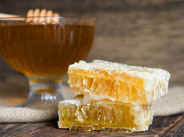 Panal de abeja con miel de cerca en una mesa de madera antigua