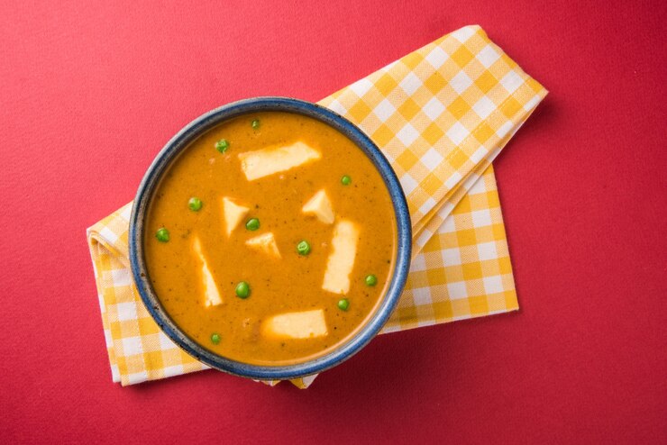Foto paneer butter masala ist ein berühmtes indisches rezept aus hüttenkäse, das in einer schüssel serviert wird. selektiver fokus