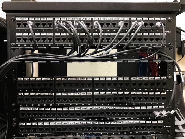 paneles de parche ethernet en la sala de comunicaciones con cables conectados a los puertos