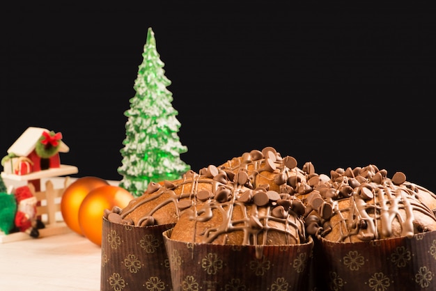 Foto panetone com enfeites de natal e fundo preto