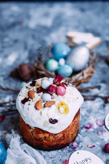 Foto panettone-osterkuchen mit baiser und dekoration auf dem tisch