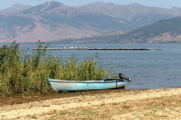 Panorama eines Bergsees Great Prespa und Boote in Nom Florina an einem sonnigen Tag Mazedonien Nordwestgriechenland