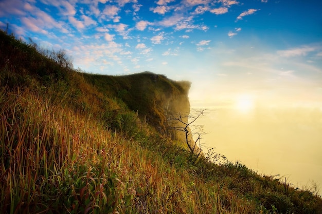 Panorama hermoso paisaje naturaleza del amanecer en la montaña pico con niebla de nubes solares y cielo brillante en