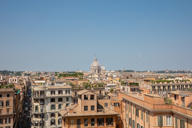 Panoramablick auf die Stadt Rom mit alten Häusern von der Spanischen Treppe. Sonniger Sommertag und blauer Himmel