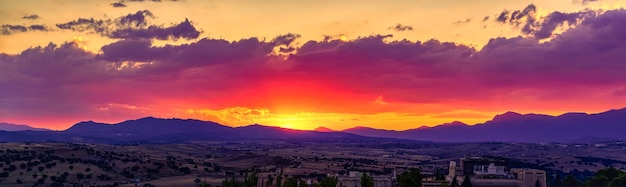 Panorámica del atardecer dorado sobre las montañas y campos boscosos del norte de Madrid en la Sierra de Guadarrama España.