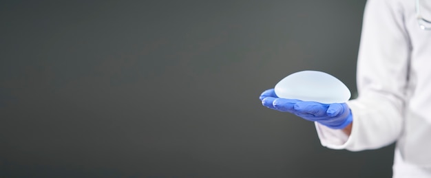 Panorâmica de um implante mamário de silicone nas mãos de um médico