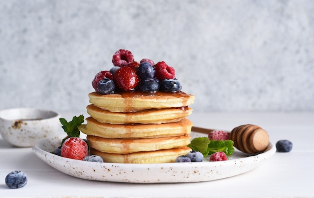 Panquecas com frutas vermelhas e xarope de bordo no café da manhã