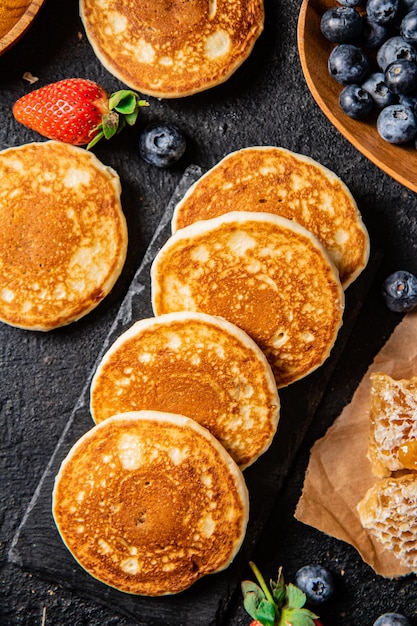 Panquecas em uma placa de pedra com frutas frescas