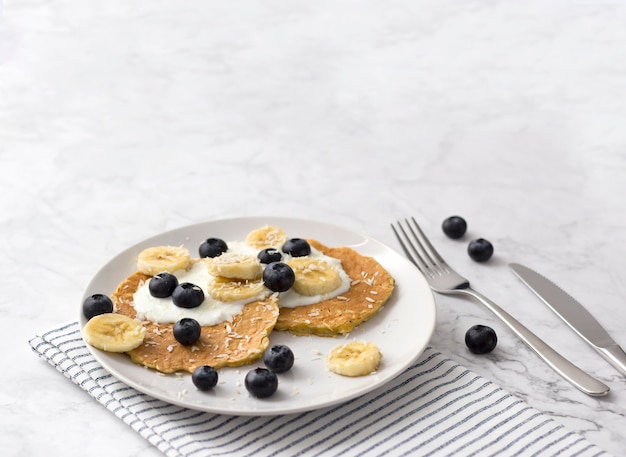 Panquecas saudáveis com frutas frescas, iogurte e frutas. conceito de café da manhã de verão.