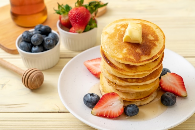 panqueque con fresas, arándanos y miel