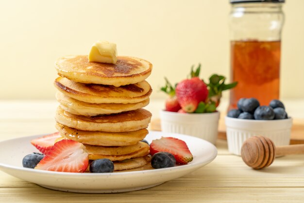 panqueque con fresas, arándanos y miel