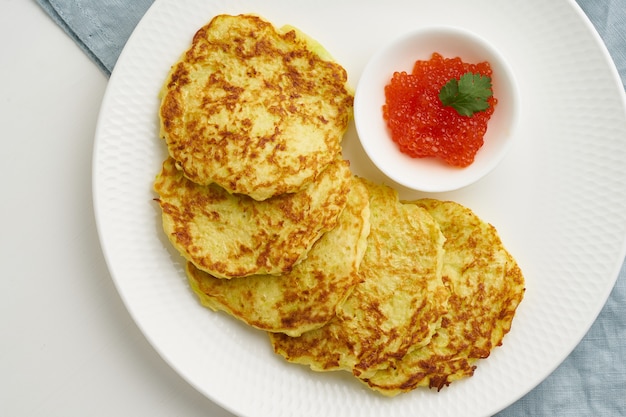 Panqueques de calabacín con patata y caviar rojo, primer plano de vista superior de dieta keto fodmap