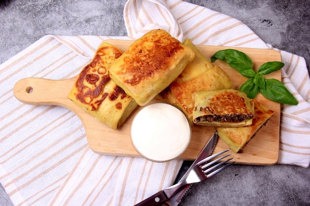 Panqueques rusos tradicionales o blini con cuajada. Tortitas rellenas de corazón picado o carne