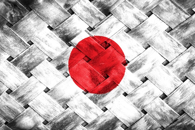 Foto pantalla de la bandera de japón en un fondo de madera de mimbre