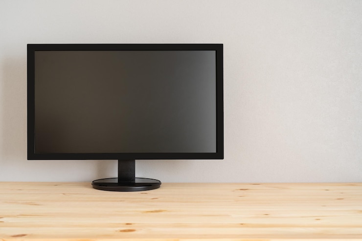 Foto una pantalla negra sobre la mesa de madera.