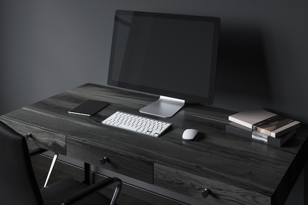 Pantalla de ordenador en blanco sobre una mesa de madera negra en una oficina moderna. Un fondo de pared negro. Vista lateral. maqueta de renderizado 3d