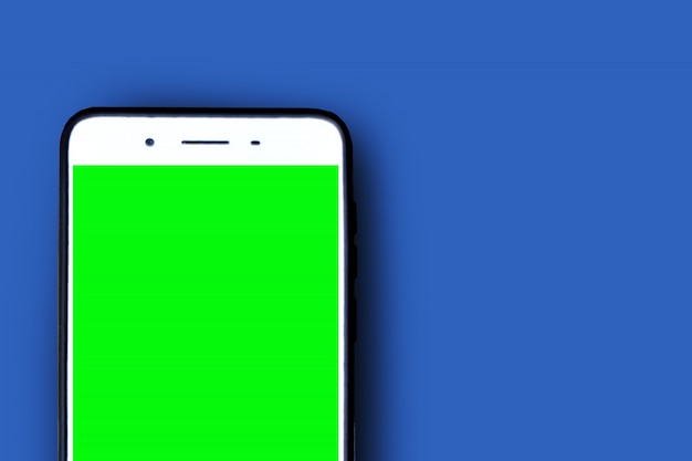 Foto pantalla de teléfono inteligente verde sobre azul