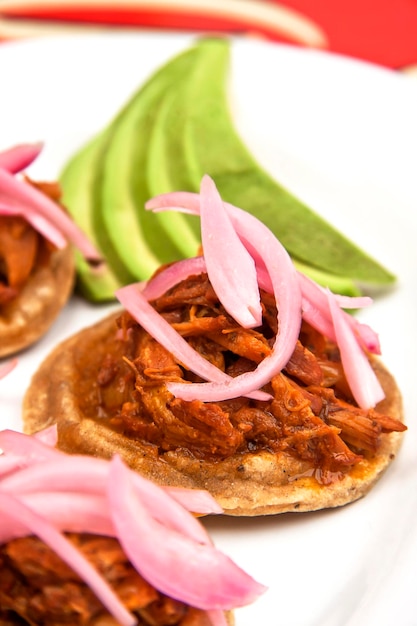 Panuchos oder sopes von cochinita pibil mit lila zwiebeln yucatecan food mexikanische gastronomie