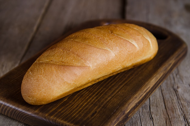 Pão caseiro fresco na mesa de madeira