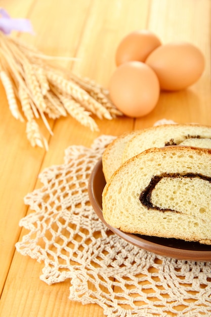 Foto pão com sementes de papoula em placa colorida em fundo de madeira