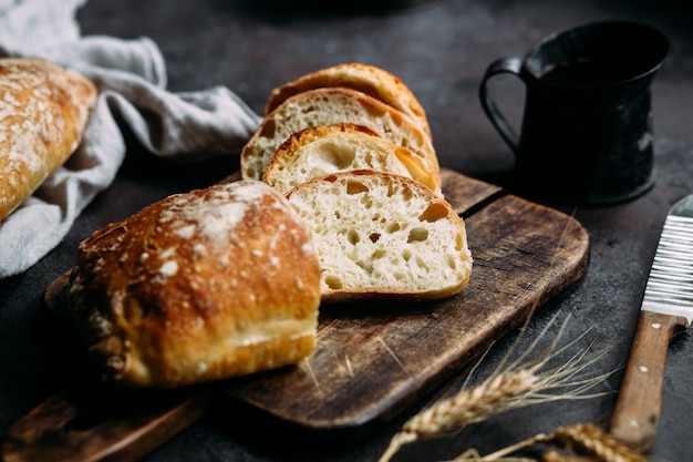 Pão de ciabatta caseiro Fatias de pão em fatias de tábua de madeira Pão