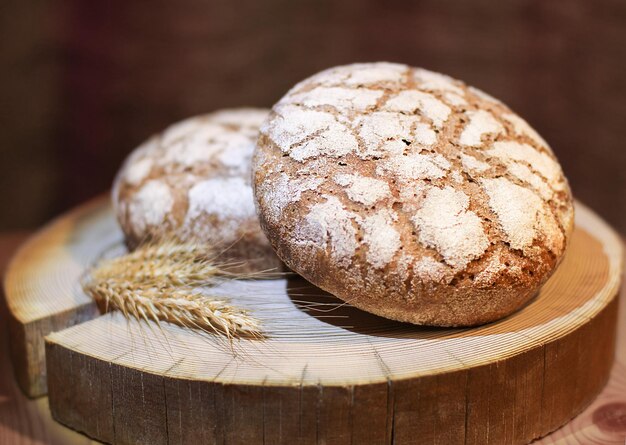 Foto pão de farinha de centeio caseiro em um círculo de madeira o conceito de alimentação saudável foco seletivo