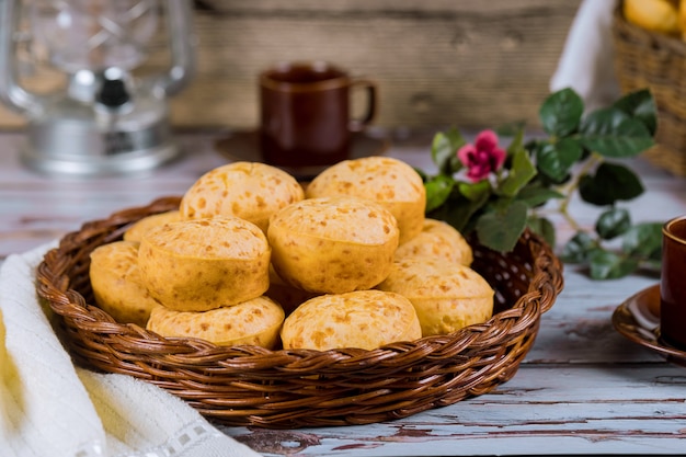 Pão de queijo, chipa com café e flores.