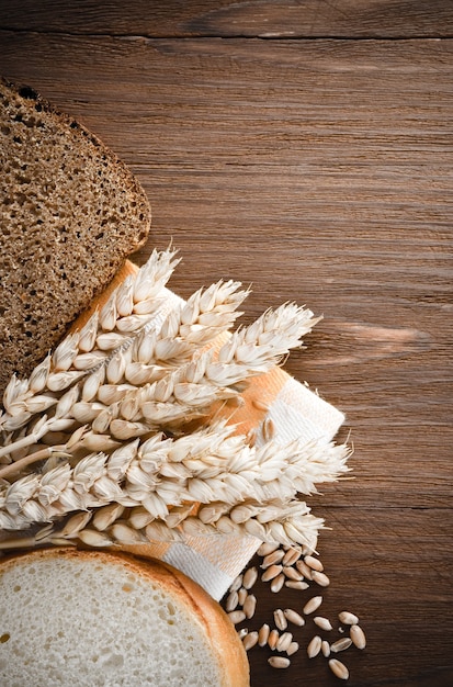 Pão fatiado e espigas de trigo no guardanapo