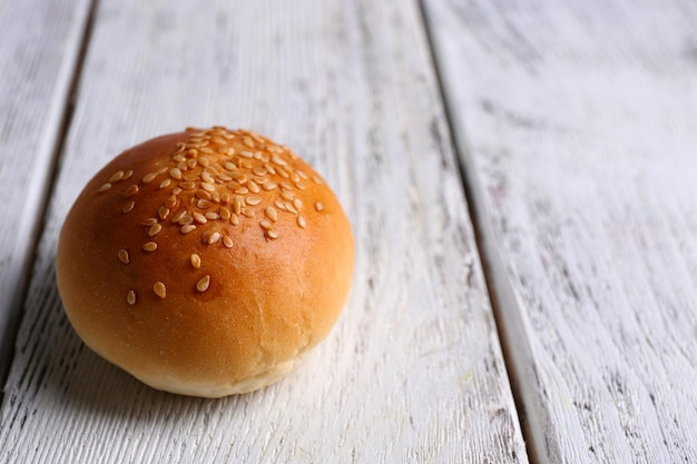 Pão saboroso com gergelim na cor de fundo de madeira