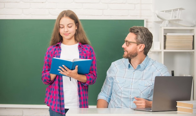 Papá e hija usan el cuaderno de regreso a la escuela, alumno nerd de educación infantil y tutor con computadora portátil