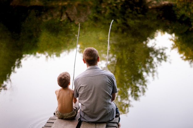 Papá e hijo pescando en un lago