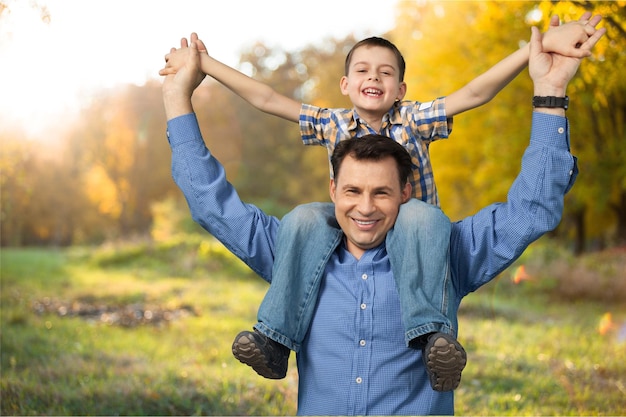 Foto papá e hijo piggy back con blue copy space