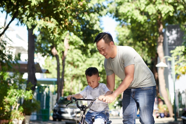Papá enseñando ciclismo para niños