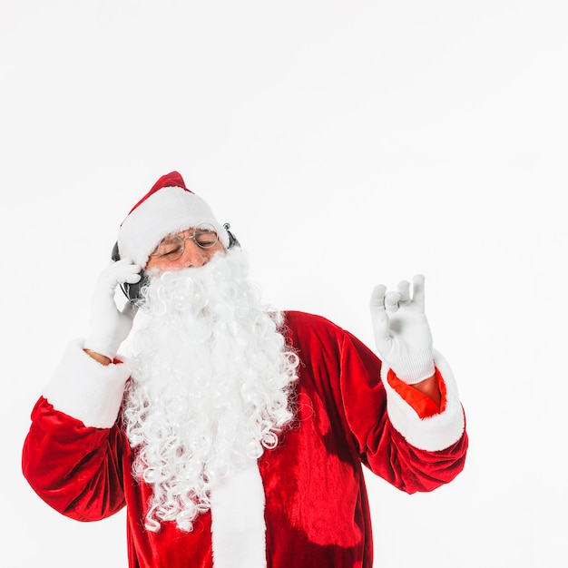 Papá Noel en copas escuchando música con auriculares