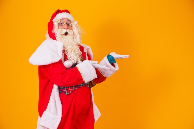 Papai Noel apontando para o lado com espaço para texto