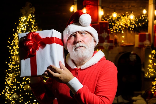Papai Noel sério segurando caixa de presente Papai Noel segurando presente de ano novo decoração de natal alegre